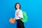 Photo of pretty funny schoolboy wear formal clothes rucksack holding book walking looking empty space  blue