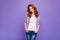 Photo of pretty ginger lady with amazing wavy hairstyle wear checkered casual shirt and blue jeans isolated purple color