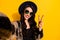 Photo of pretty happy young woman wear cool glasses make v-sign selfie face isolated on yellow color background