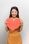 Photo of pretty lady hold hands hugging red paper heart affectionate   on white background