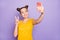 Photo of pretty lady holding telephone showing v-sign symbol making selfies for social blog wear yellow t-shirt isolated
