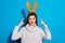 Photo of pretty lady indicating on her head angry with wearing toy horns knitted pullover isolated blue background