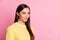 Photo of pretty shiny young lady wear casual yellow outfit looking empty space isolated pastel pink color background