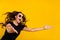Photo of pretty shocked young woman wear black outfit dark eyeglasses catching holding empty space isolated yellow color