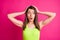 Photo of pretty surprised young lady open mouth hands head wear lime top  vibrant pink color background