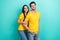 Photo of pretty sweet husband wife dressed yellow t-shirts embracing smiling empty space isolated turquoise color