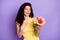 Photo of pretty young girl arm on chest hold flowers fascinated have good mood isolated on violet color background
