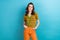 Photo of pretty young girl wear trendy t-shirt vintage orange pants smiling optimistic good mood model isolated on blue