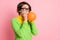 Photo of pretty young woman inflate balloon prepare celebration event look copyspace isolated on pastel pink color