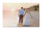 Photo printed on canvas, white background. Bride and groom walking at sunset