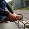 photo of a project worker cutting iron using a grinding machine