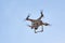 Photo of a quadrocopter against a blue sky