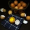 Photo of raw eggs. Egg yolk and cracking egg