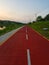 photo of red asphalt road specifically for two-wheeled vehicles and pedestrians