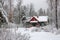 A photo of a red house nestled amidst a winter wonderland of snow-covered trees, A traditional Russian dacha in winter, AI