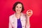 Photo of reliable positive grandma lady demonstrate grapefruit slice wear pink jacket isolated red color background