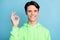 Photo of reliable promoter guy shiny smile show okey sign wear green hoodie isolated blue color background