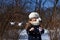 A photo representing a concept of coming spring - a smiling little girl in a park with paper cranes