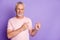 Photo of retired grandpa indicate fingers empty space wear pink t-shirt isolated violet color background