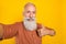 Photo of retired man make selfie show thumb-up select suggest good ad isolated over yellow color background