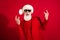 Photo of retired pensioner crazy happy old man wear sunglass rock signs sants claus isolated on red color background