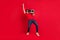 Photo of retro disco dancer guy hold boombox dance wear red t-shirt jeans shoes  red color background