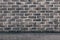 Photo of retro gray brickwall with light with copy space. Concept for backdrop, background, banner, brick pattern, construction