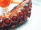 Photo of roasted tentacle octopus served with spicy sauce