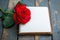 Photo Romantic ambiance present, red rose, and notebook on wood