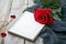 Photo Romantic ambiance present, red rose, and notebook on wood