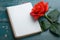 Photo Romantic ambiance present, red rose, and notebook on wood