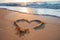 Photo Romantic gesture heart painted in sand on picturesque beach