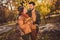 Photo of romantic harmony couple go autumn october park girl hold maple leaves wear season outerwear