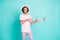 Photo of romantic man hold bow shoot arrow wear pink cap spectacles t-shirt pants isolated on teal color background