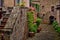 Photo of romantic square in ancient town Civita in Italy with flowers and stairs