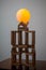 Photo of a round glowing yellow ball on brown wooden blocks