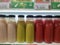 photo Rows of healthy and refreshing fruit juice bottles neatly arranged, with a blur effect in the background