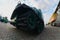 Photo of a Russian green armored car on a caterpillar track among the railway trains. Strong distortion from the fisheye len