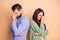 Photo of sad couple fist head wear cardigan sweater isolated on beige color background