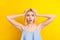 Photo of sad impressed blond short hair lady hands head wear blue top isolated on vivid yellow color background