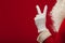 Photo of Santa Claus gloved hand in pointing gesture. fingers