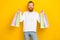 Photo satisfied positive man hand arm hold new clothes choose nice outfit enjoy isolated on yellow color background