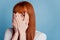 Photo of scared girl close palm mouth isolated on blue background