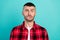 Photo of scared millennial brunet guy bite lip wear checkered shirt isolated on teal color background