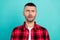 Photo of scared millennial brunet guy wear red shirt isolated on teal color background