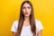 Photo of scared millennial brunette lady wear white t-shirt isolated on yellow color background