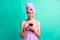Photo of scared troubled lady bite lips morning shower hold telephone wear violet towels isolated teal color background