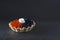 A photo of seafood. Red salmon and black sturgeon caviar with cream cheese in a tartlet on the dark background with copyspace,