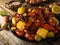 In the photo we see a beautiful still life of appetizing crayfish, bright yellow pieces of boiled corn. Also on a wooden table in