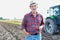 Photo of Senior farmer standing on tractor at field